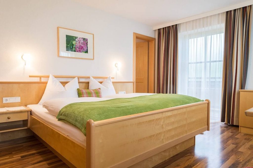 Komfortables Zimmer im Bio-Bauernhof mit Panoramablick und modernem Holzdesign.